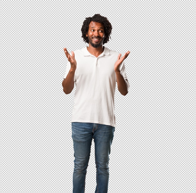 Handsome african american surprised and shocked, looking with wide eyes, excited