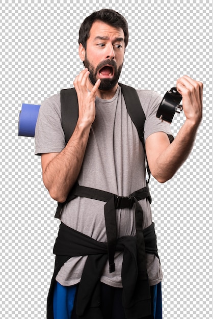 Handsome backpacker holding vintage clock