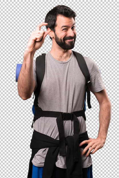 Handsome backpacker making tiny sign