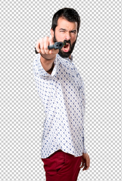 Handsome brunette man with beard holding a pistol