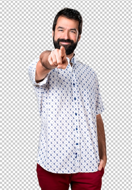 Handsome brunette man with beard pointing to the front