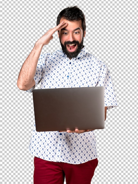 Handsome brunette man with beard with laptop