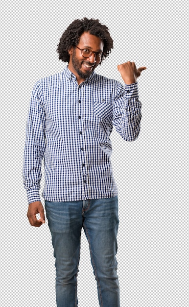 PSD handsome business african american man pointing to the side, smiling surprised presenting