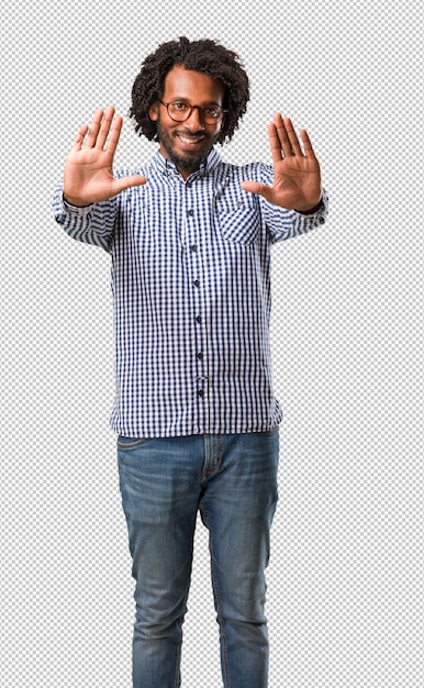 Handsome business african american man serious and determined, putting hand in front, stop gesture, deny concept