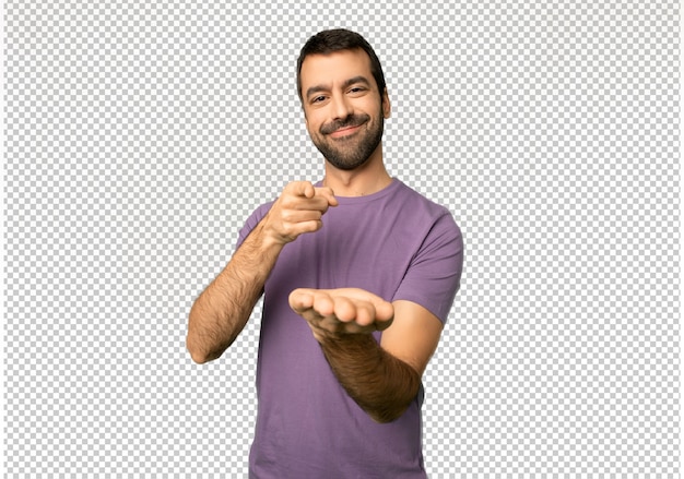 Handsome man holding copyspace imaginary on the palm to insert an ad