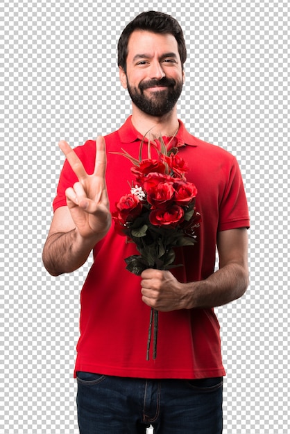 Handsome man holding flowers counting two