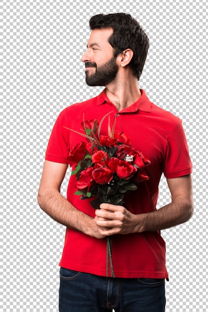 Handsome man holding flowers looking lateral