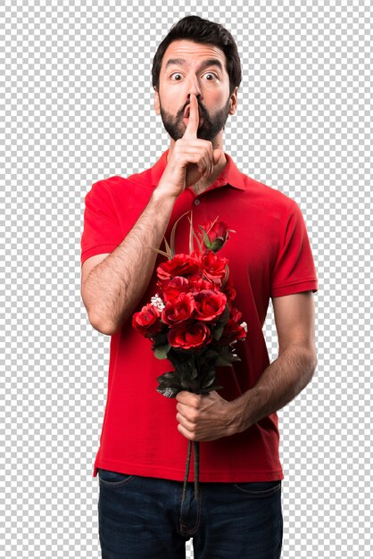 PSD handsome man holding flowers making silence gesture