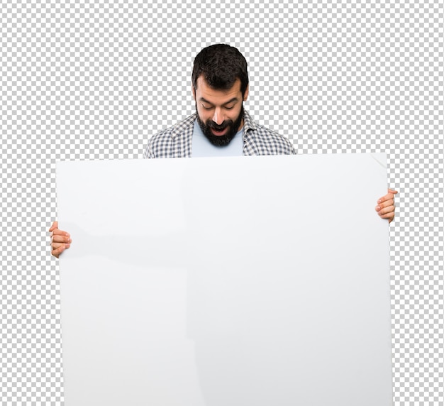 Handsome man with beard holding an empty placard