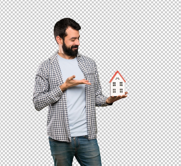 PSD handsome man with beard holding a little house