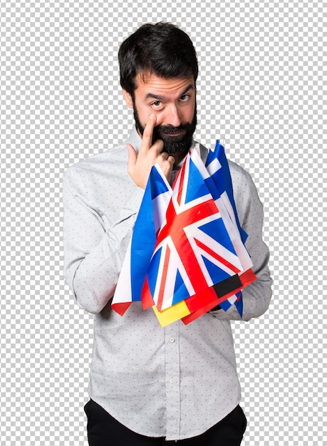 Handsome man with beard holding many flags and showing something