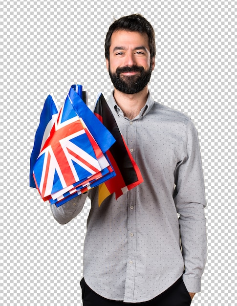 Handsome man with beard holding many flags