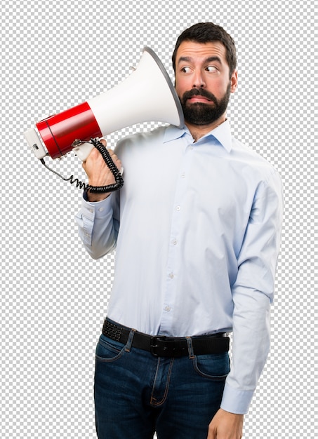 Handsome man with beard holding a megaphone