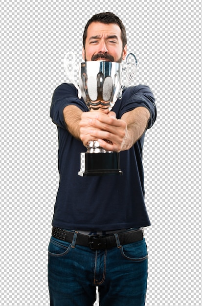 Handsome man with beard holding a trophy