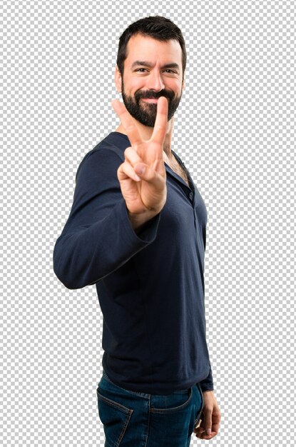 Handsome man with beard making victory gesture