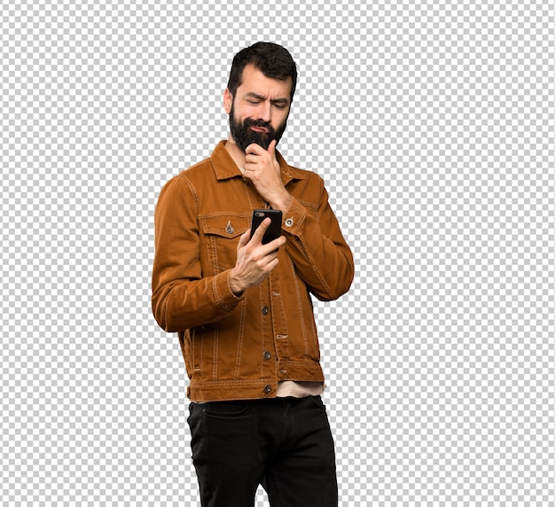 handsome man with beard thinking and sending a message