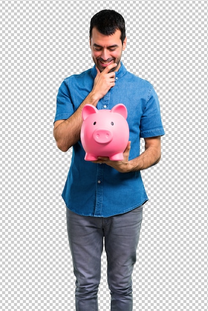 handsome man with blue shirt holding a piggybank