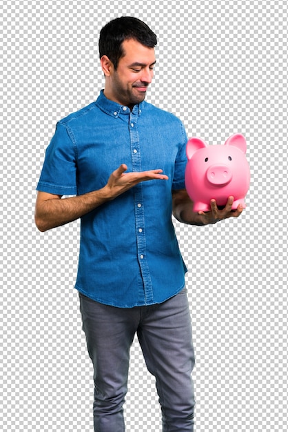 handsome man with blue shirt holding a piggybank