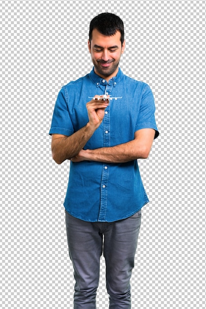 Handsome man with blue shirt holding a toy airplane