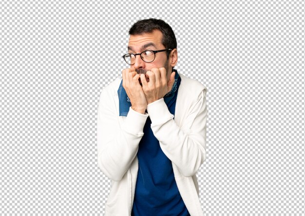 PSD handsome man with glasses is a little bit nervous and scared putting hands to mouth