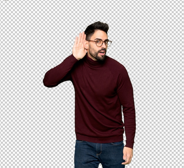 PSD handsome man with glasses listening to something by putting hand on the ear