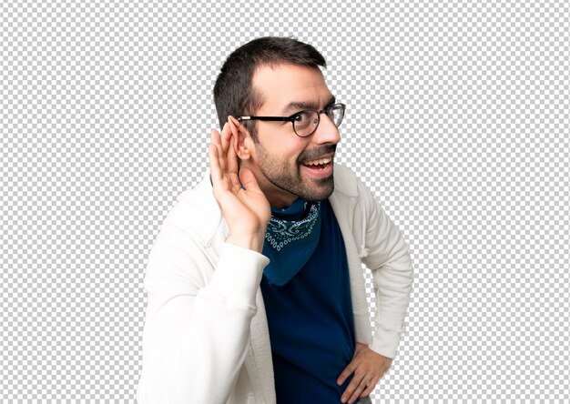 Handsome man with glasses listening to something by putting hand on the ear