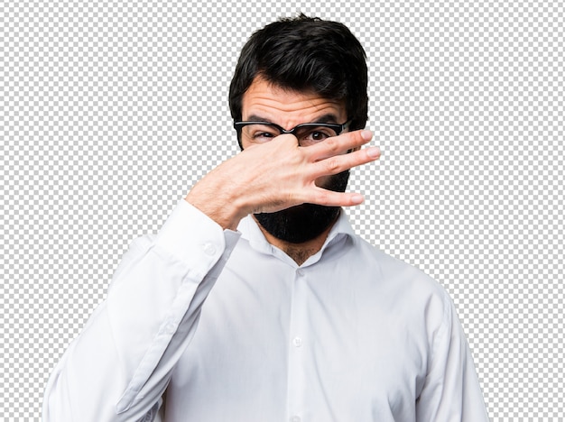 PSD handsome man with glasses making smelling bad gesture