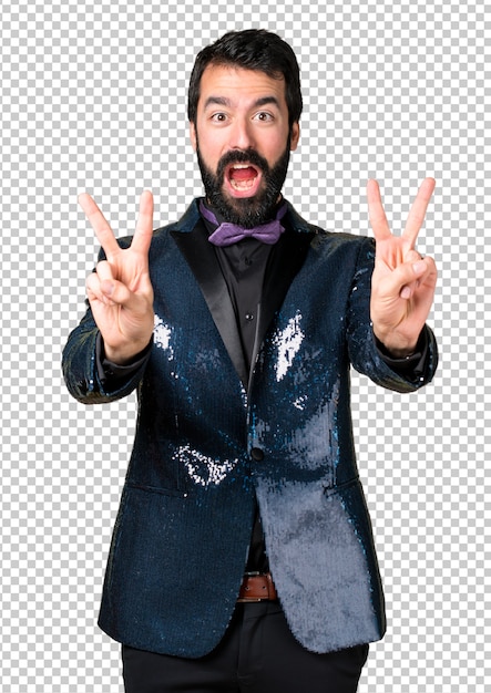 Handsome man with sequin jacket making victory gesture