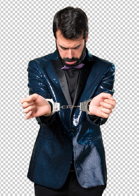 Handsome man with sequin jacket with handcuffs