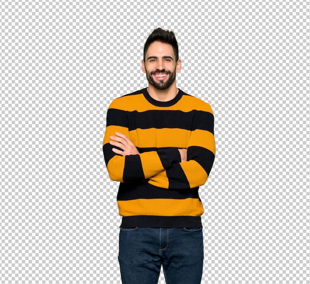 Handsome man with striped sweater keeping the arms crossed in frontal position