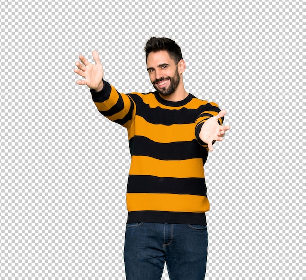 PSD handsome man with striped sweater presenting and inviting to come with hand