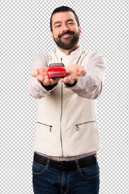 PSD handsome man with vest holding a little car