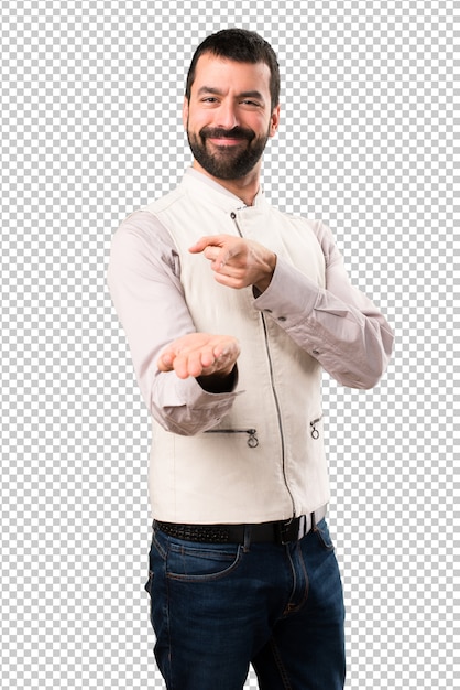 Handsome man with vest holding something