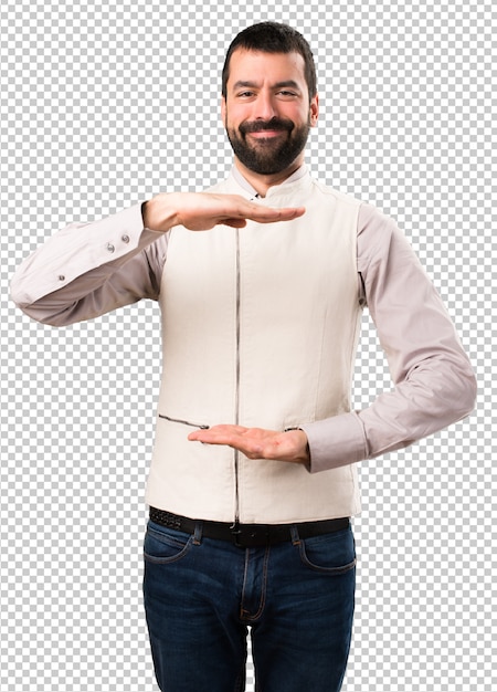 Handsome man with vest holding something