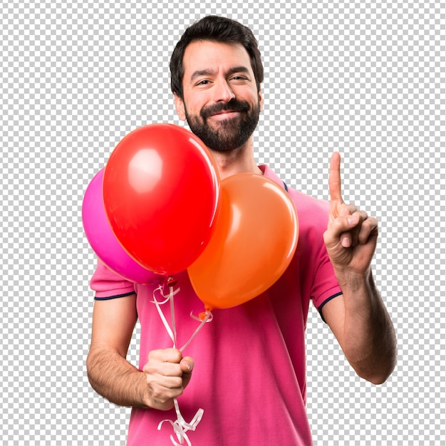 Handsome young man holding balloons and  counting one