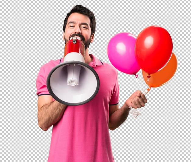 Handsome young man holding balloons and  holding a megaphone