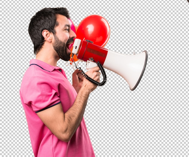 Handsome young man holding balloons and  holding a megaphone