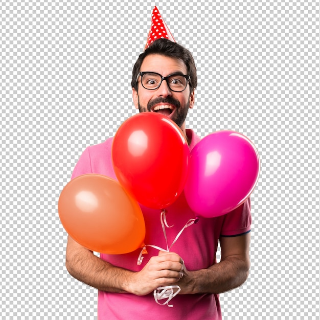 Handsome young man holding balloons