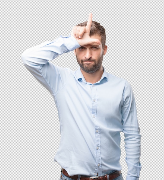 Handsome young man making looser sign