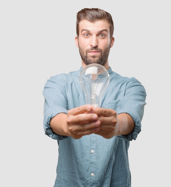 Handsome young man with light bulb