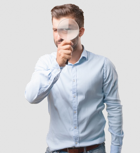 Handsome young man with magnifying glass