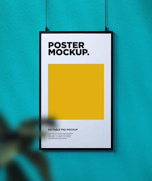 A hanging poster mockup with a plant foreground