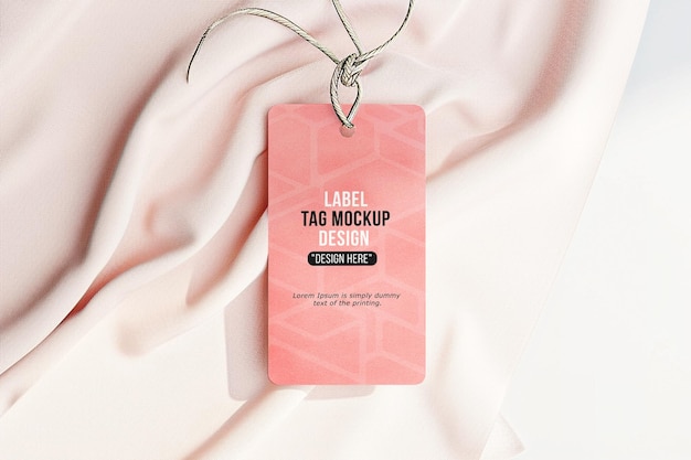 PSD hanging tag label mockup clothing label tag on soft fabric