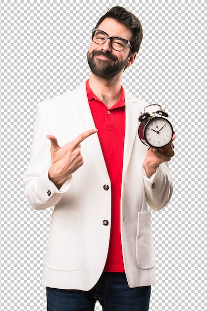 Happy brunette man with glasses holding vintage clock