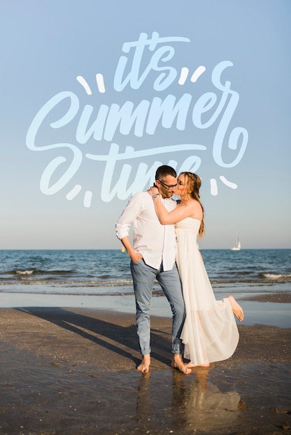 happy couple hugging by the seashore