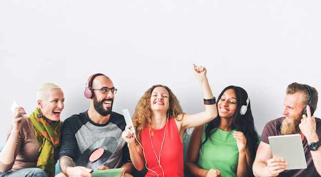 Happy group of friends sharing and listening to music