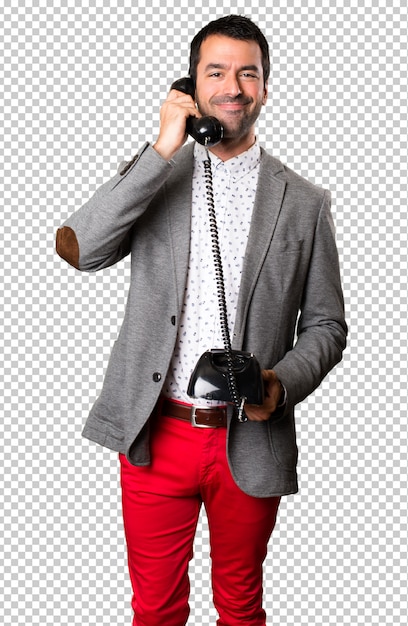 Happy handsome man talking to vintage phone