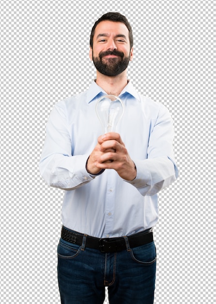 Happy handsome man with beard holding a bulb