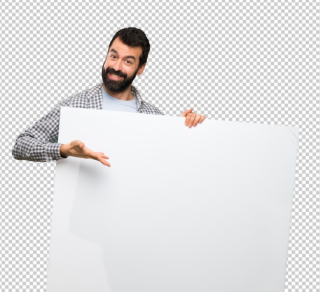 Happy handsome man with beard holding an empty placard