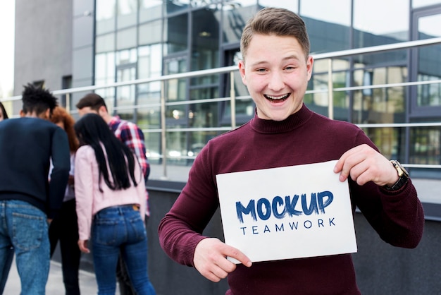 Happy man holding teamwork mock-up